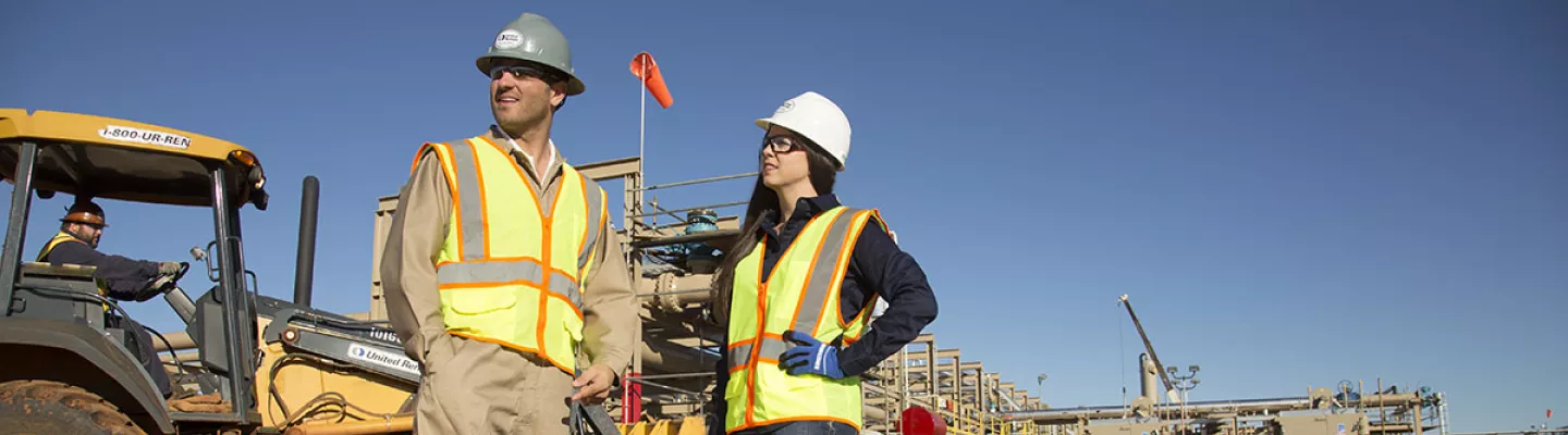 man and woman on jobsite in ppe