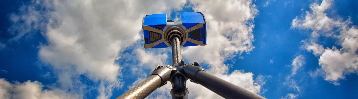 portable 3d laser scanner with blue sky and clouds