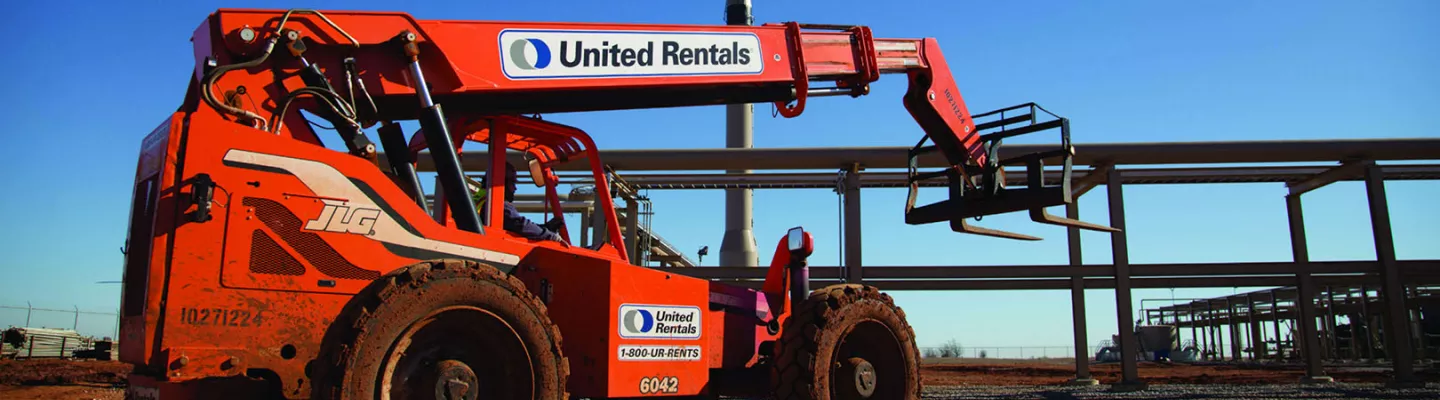 Orange JLG forklift with United Rentals branding against a blue sky