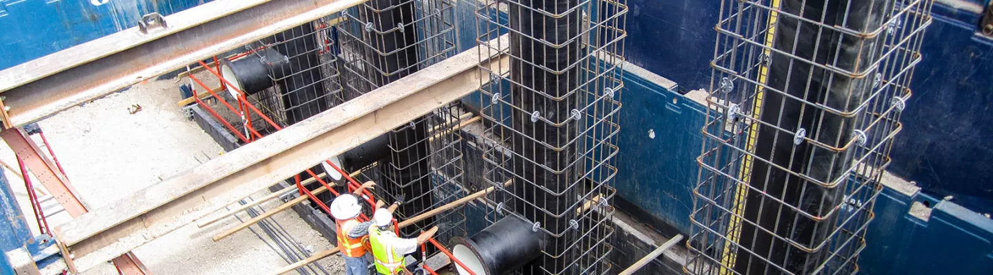 birdseye view of a trench jobsite with workers standing on composite matting