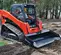 Black Paladin skit steer bucket attached to an orange skid steer