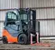 Orange and black Toyota warehouse forklift with scale