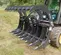 Gray Paladin Root Grapple Bucket Attachment on a Skid Steer
