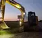 Yellow and gray KOBELCO 30,000-35,000 lb. Excavator, Zero Tail Swing