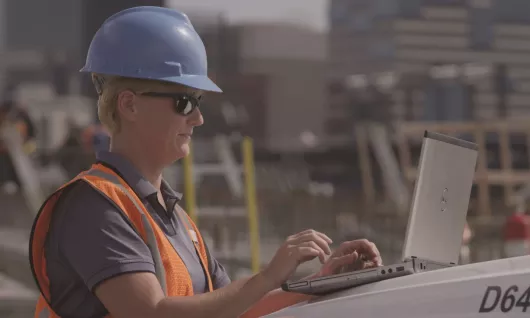 woman on jobsite with laptop
